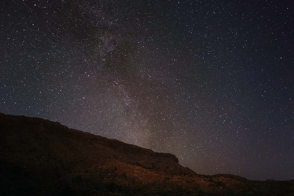milky way mountain under starry sky night